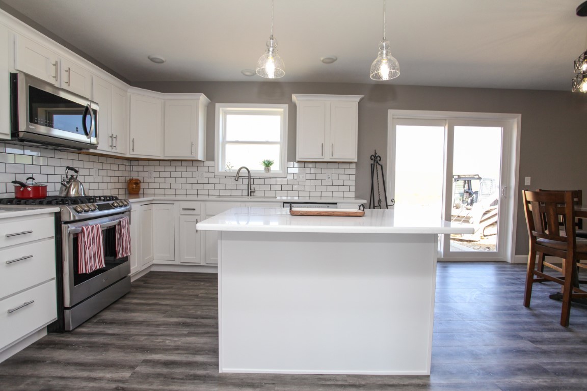 2238 Heather Ridge Drive Normal, IL 61761 - Photo 8 of 26 a kitchen with stainless steel appliances granite countertop wooden cabinets a sink a stove a dining table and chairs