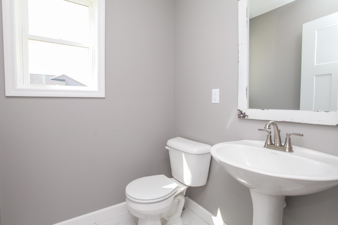 2238 Heather Ridge Drive Normal, IL 61761 - Photo 10 of 26 a white toilet sitting next to a bathroom sink