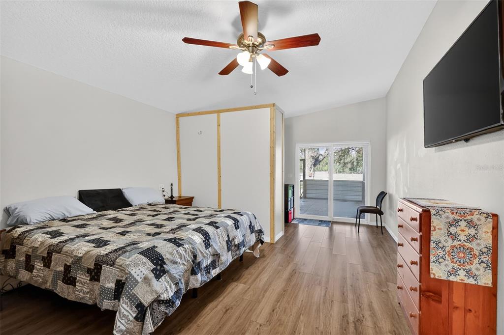 4533 Southwest 37th Terrace Bushnell, FL 33513 - Photo 23 of 58 a bedroom with a bed and a flat screen tv