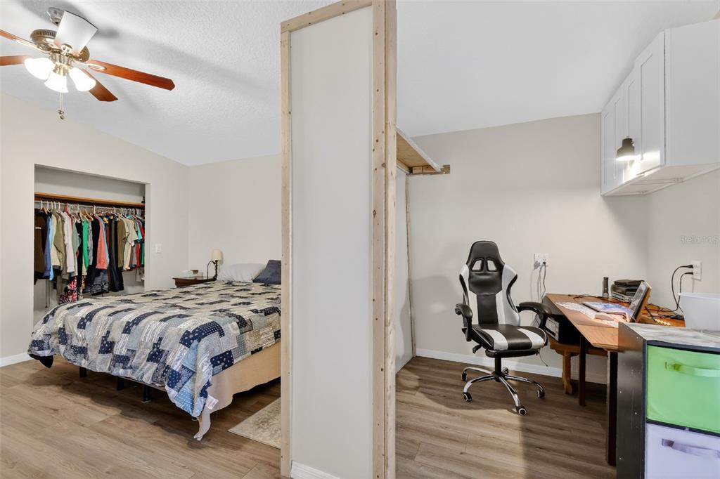 4533 Southwest 37th Terrace Bushnell, FL 33513 - Photo 24 of 58 a bedroom with a bed and a chandelier