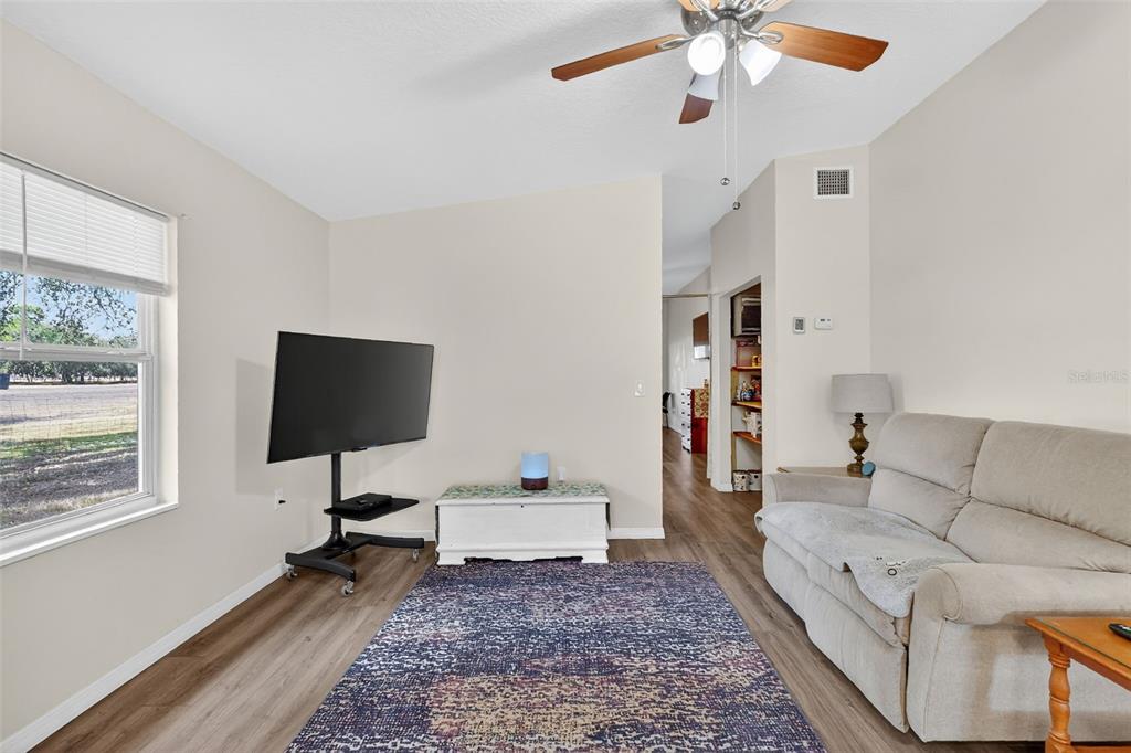 4533 Southwest 37th Terrace Bushnell, FL 33513 - Photo 34 of 58 a living room with furniture and a flat screen tv