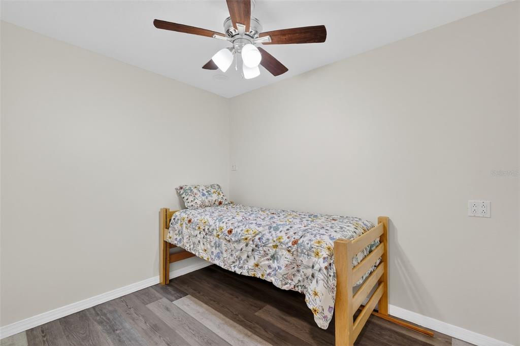 4533 Southwest 37th Terrace Bushnell, FL 33513 - Photo 39 of 58 a bedroom with a bed and a ceiling fan