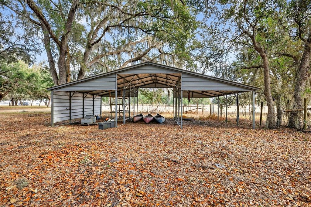 4533 Southwest 37th Terrace Bushnell, FL 33513 - Photo 6 of 58 a backyard of a house with table and chairs