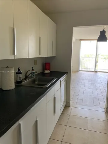 a kitchen with a sink and cabinets