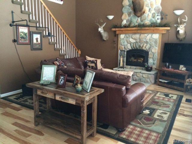 8028 McClements Road Brighton, MI 48114 - Photo 8 of 28 Hickory floors, cathedral ceiling and stone fireplace!