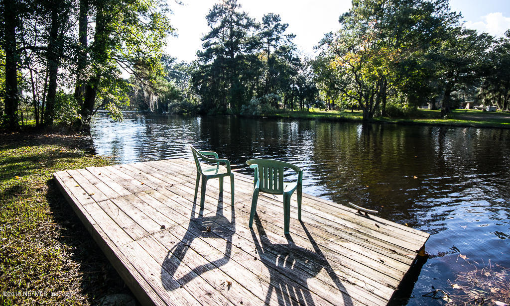 10504 Rutgers Road Jacksonville, FL 32218 - Photo 1 of 32 a view of a wooden deck with lake and trees