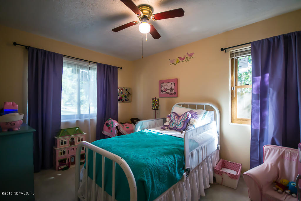 10504 Rutgers Road Jacksonville, FL 32218 - Photo 16 of 32 a bedroom with furniture and a window