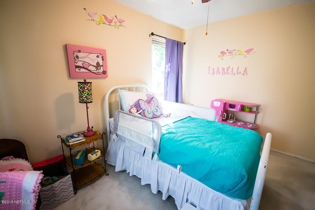 10504 Rutgers Road Jacksonville, FL 32218 - Photo 17 of 32 a bedroom with a bed and a window