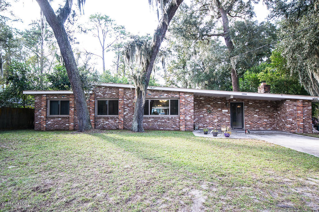 10504 Rutgers Road Jacksonville, FL 32218 - Photo 2 of 32 a backyard of a house with table and chairs