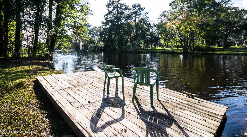 10504 Rutgers Road Jacksonville, FL 32218 - Photo 22 of 32 a view of a patio with chairs next to a lake