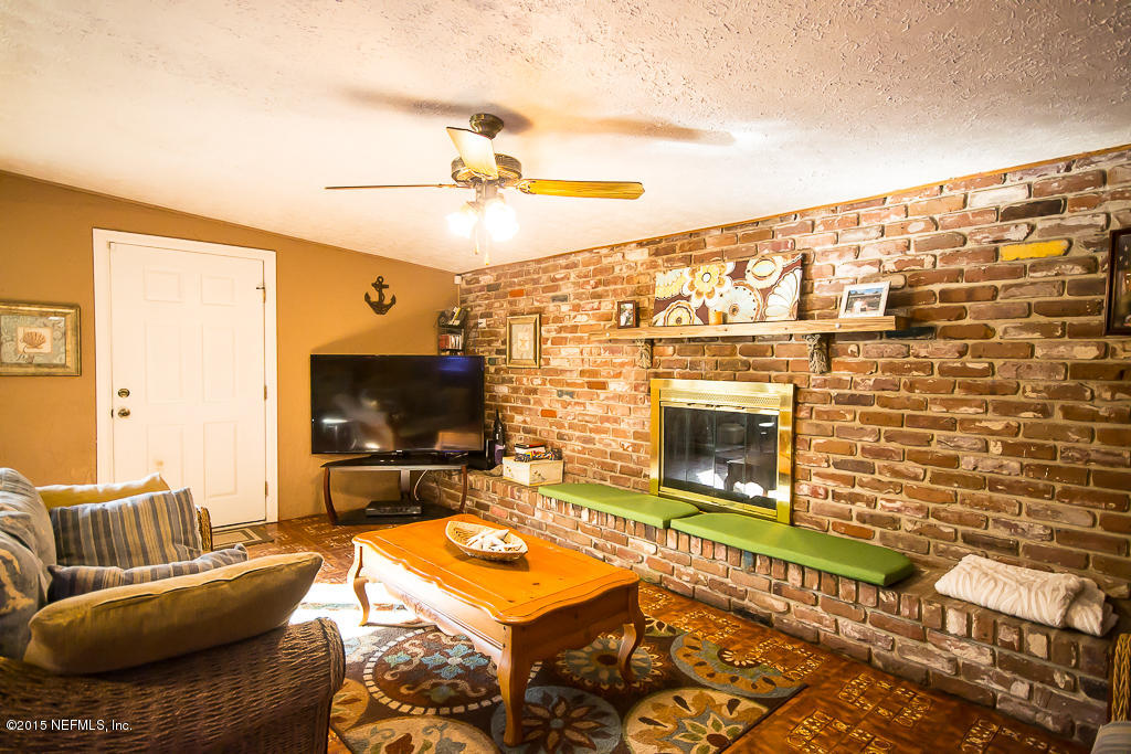 10504 Rutgers Road Jacksonville, FL 32218 - Photo 8 of 32 a living room with furniture and a flat screen tv