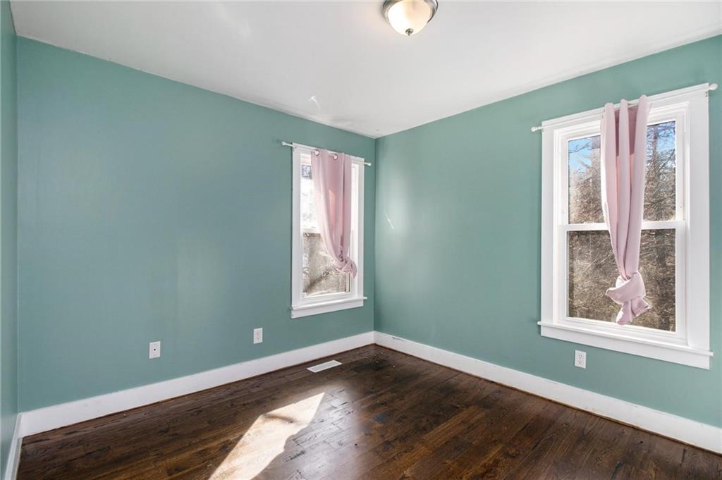 1585 Golden Pond Road Buchanan, GA 30113 - Photo 12 of 30 an empty room with wooden floor and windows