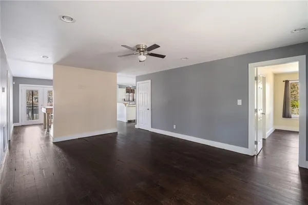 a view of an empty room with wooden floor