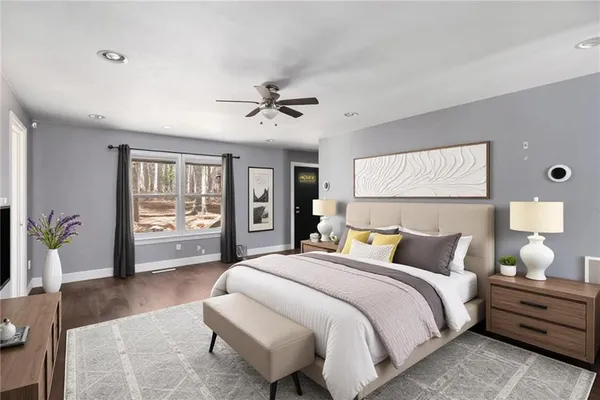 a spacious bedroom with a bed a chandelier and a flat screen tv