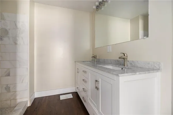 a bathroom with a granite countertop sink and a mirror