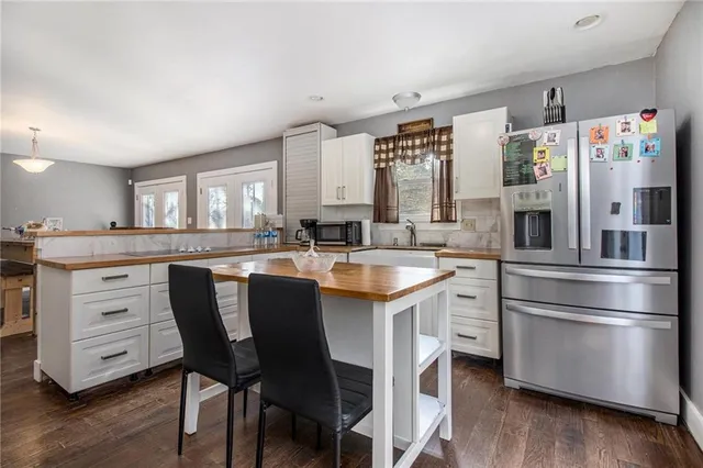 a kitchen with a table chairs sink and cabinets