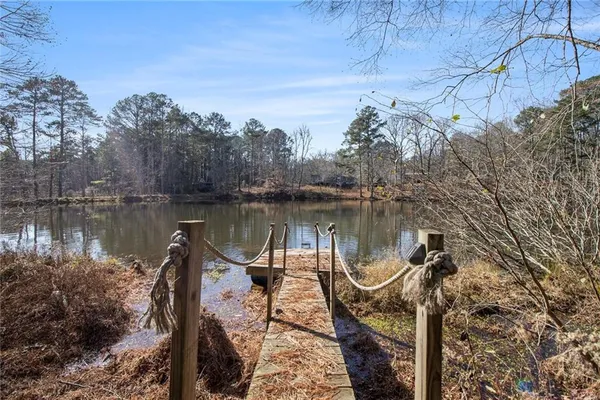 a lake view with a wooden bridge
