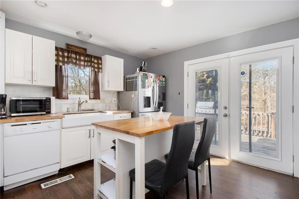 1585 Golden Pond Road Buchanan, GA 30113 - Photo 20 of 30 a kitchen with a table chairs sink and cabinets