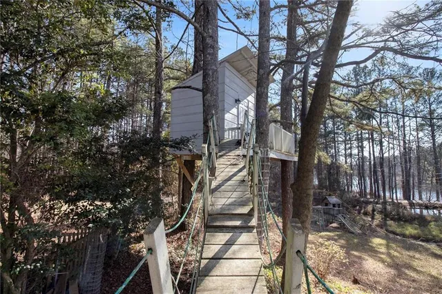 a view of a house with large trees