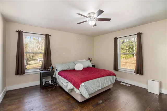 a bed sitting in a bedroom next to a window
