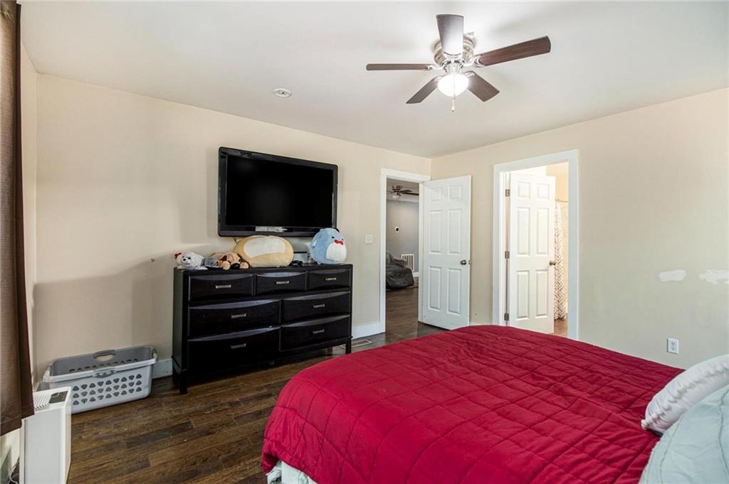 1585 Golden Pond Road Buchanan, GA 30113 - Photo 10 of 30 a bedroom with a bed and a flat screen tv