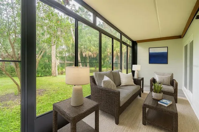 a living room with furniture and a floor to ceiling window
