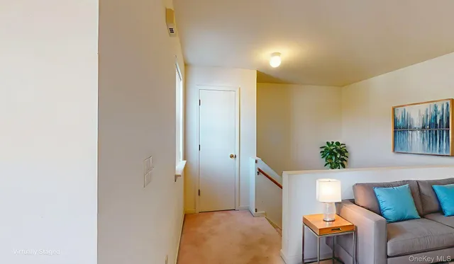a view of a hallway with windows and chandelier