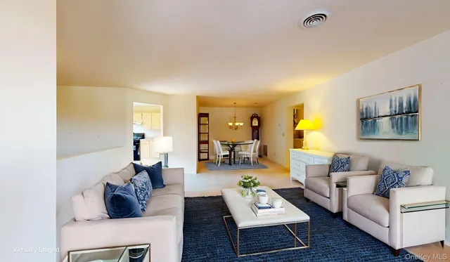 a view of a dining room with furniture a chandelier and wooden floor