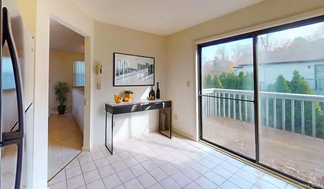 a kitchen with stainless steel appliances granite countertop a refrigerator a stove a sink dishwasher and white cabinets with wooden floor