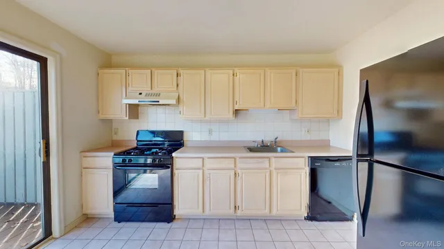 a view of a kitchen with fridge and wooden floor