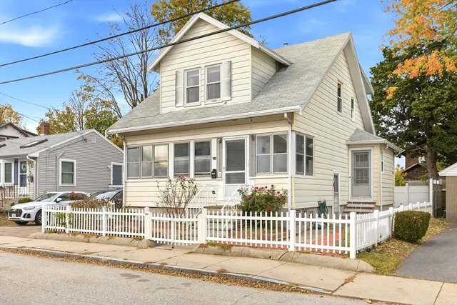 a front view of a house with a iron gate
