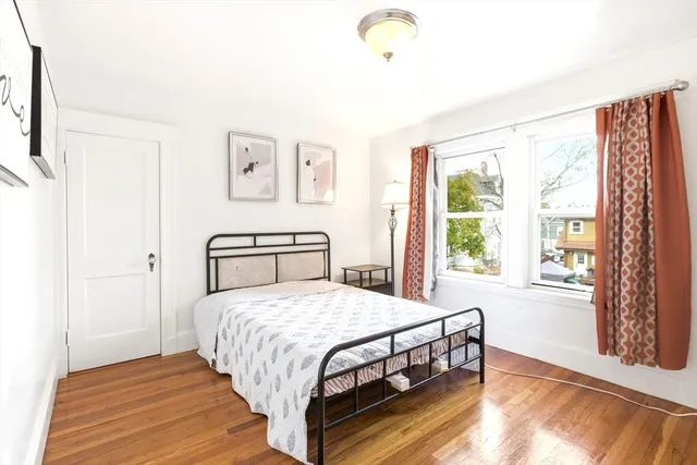 a bedroom with a bed and a large window