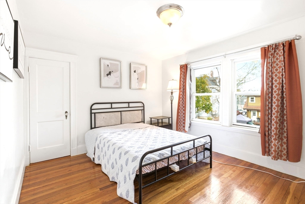 58 Bayfield Road Quincy, MA 02171 - Photo 13 of 27 a bedroom with a bed and a large window