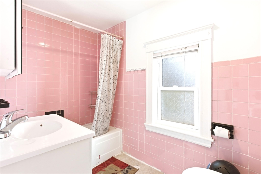 58 Bayfield Road Quincy, MA 02171 - Photo 19 of 27 a bathroom with a sink a bath tub and a shower curtain