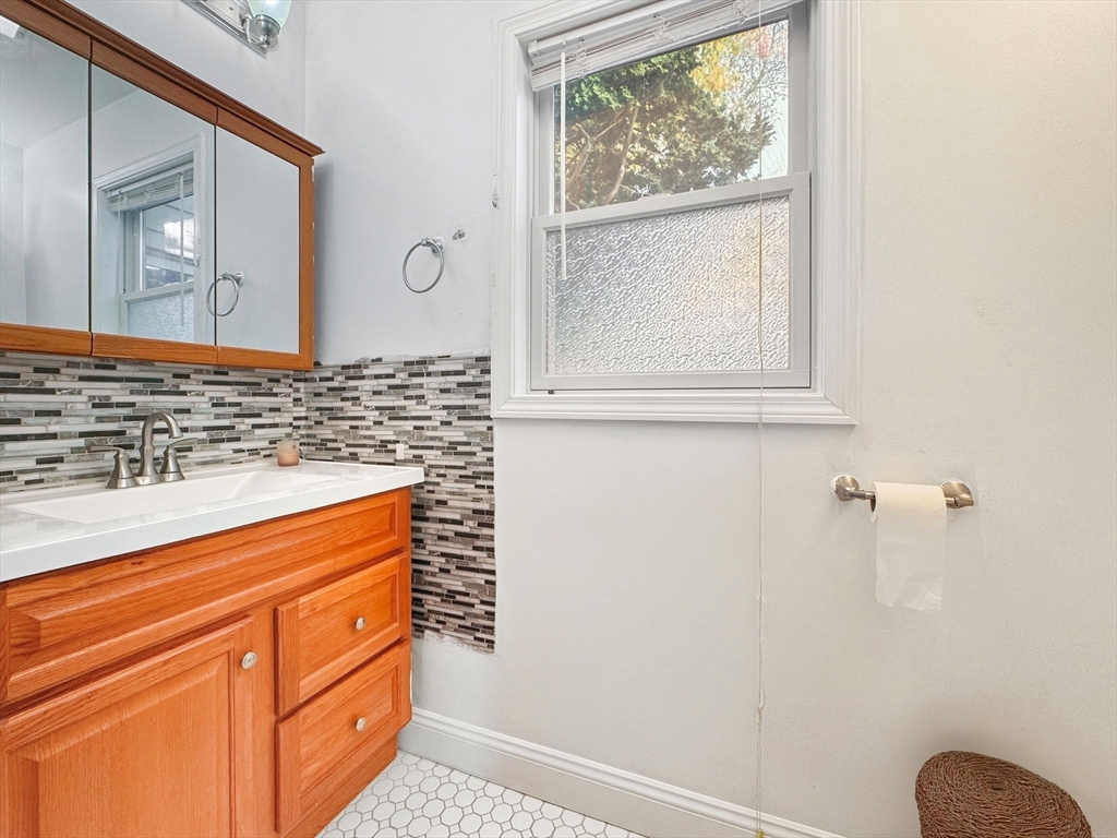 58 Bayfield Road Quincy, MA 02171 - Photo 20 of 27 a bathroom with a sink a mirror and a window