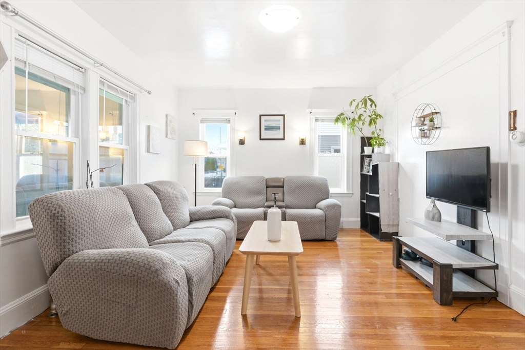 58 Bayfield Road Quincy, MA 02171 - Photo 2 of 27 a living room with furniture and a flat screen tv