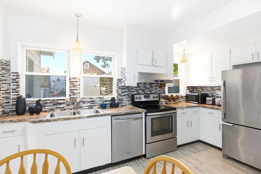 58 Bayfield Road Quincy, MA 02171 - Photo 5 of 27 a kitchen with white cabinets appliances and a window