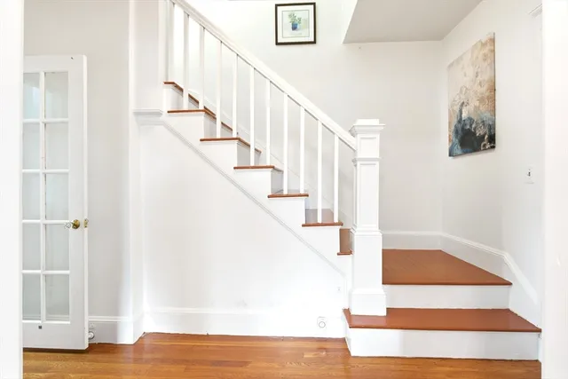 a view of entryway and hall with wooden floor