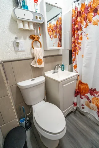 a bathroom with a sink toilet and a mirror