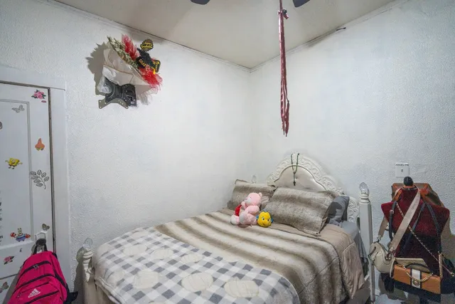 a bedroom with a bed and a chandelier