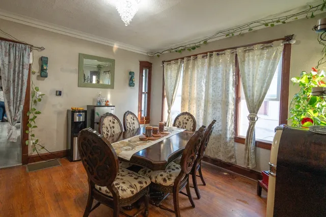 a view of a a dining room with furniture window and wooden floor