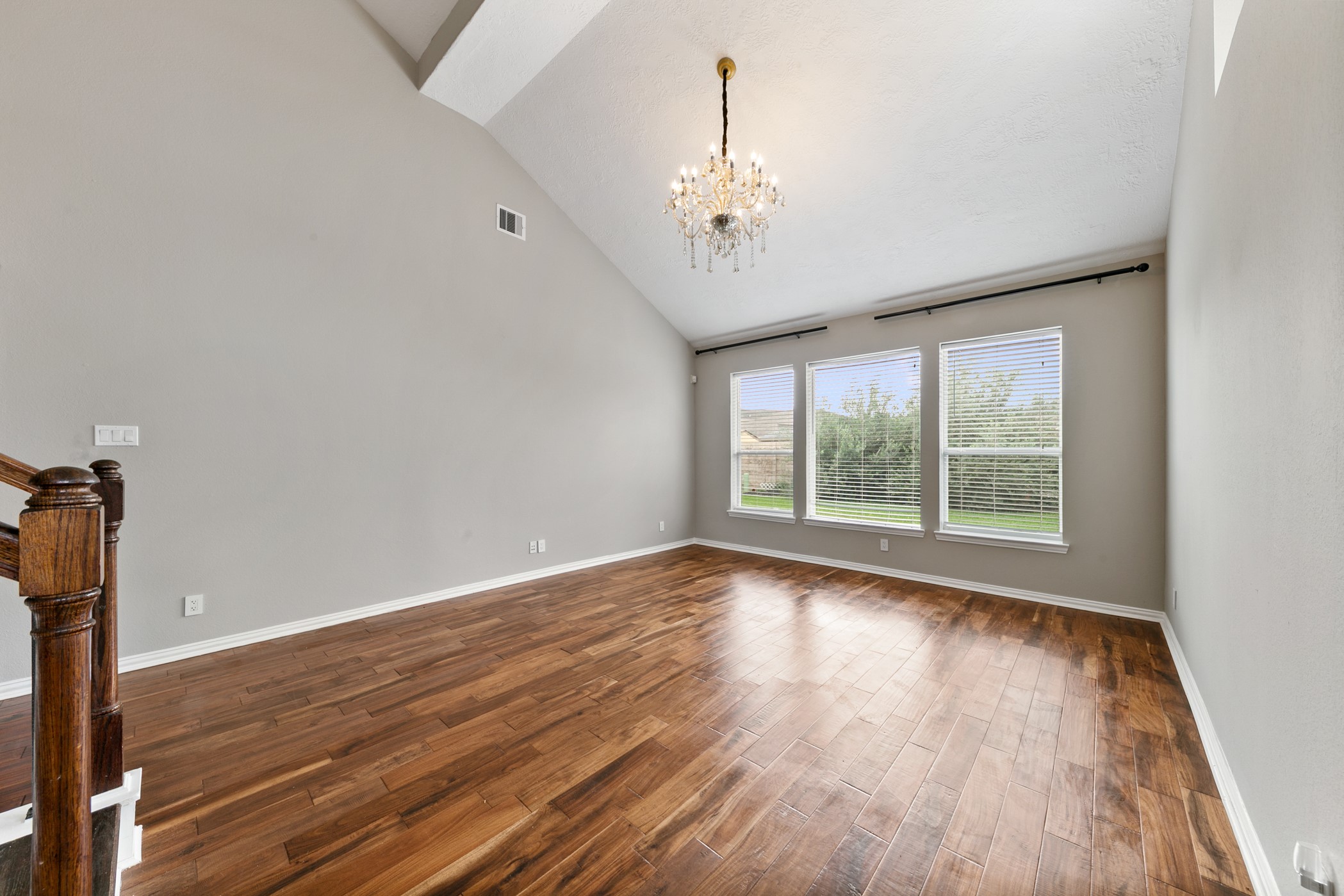 9438 Emerald Lakes Drive Rosharon, TX 77583 - Photo 5 of 36 a view of an empty room with wooden floor and a window