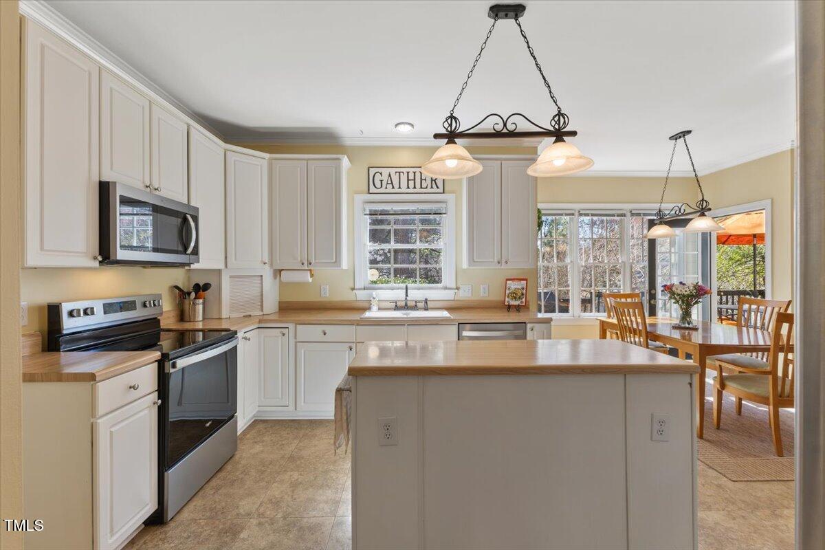 4617 Wee Burn Trail Raleigh, NC 27612 - Photo 28 of 70 a kitchen with stainless steel appliances granite countertop a stove and a sink