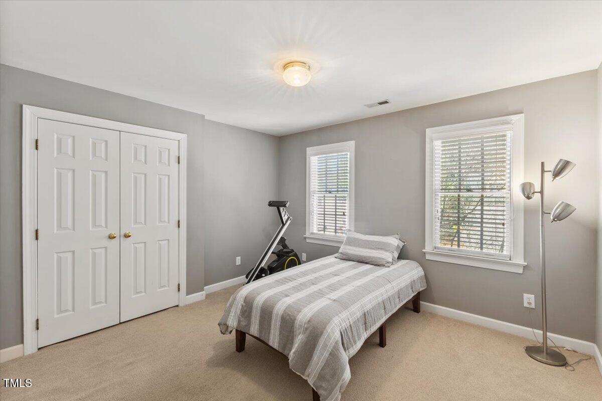4617 Wee Burn Trail Raleigh, NC 27612 - Photo 45 of 70 a bedroom with a bed and a window