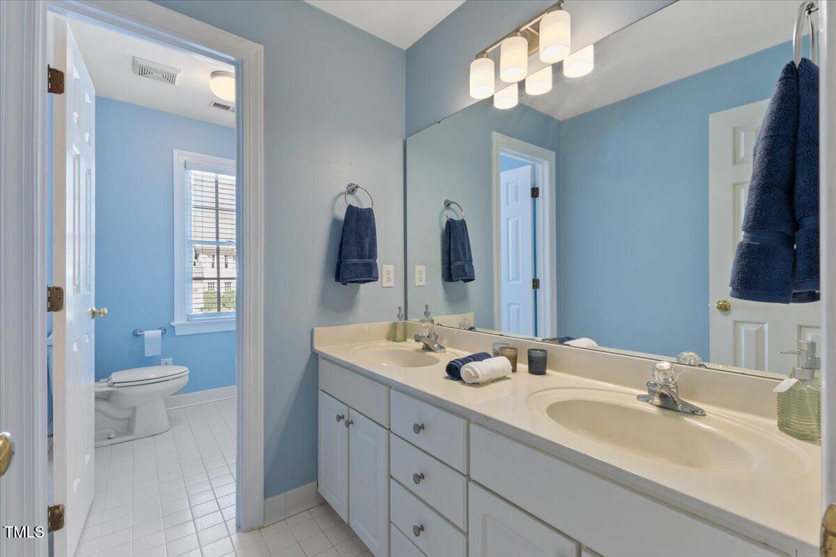 4617 Wee Burn Trail Raleigh, NC 27612 - Photo 51 of 70 a bathroom with a sink double vanity granite and a toilet