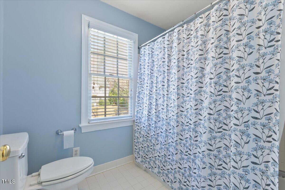 4617 Wee Burn Trail Raleigh, NC 27612 - Photo 53 of 70 a bathroom with a toilet and a shower curtain