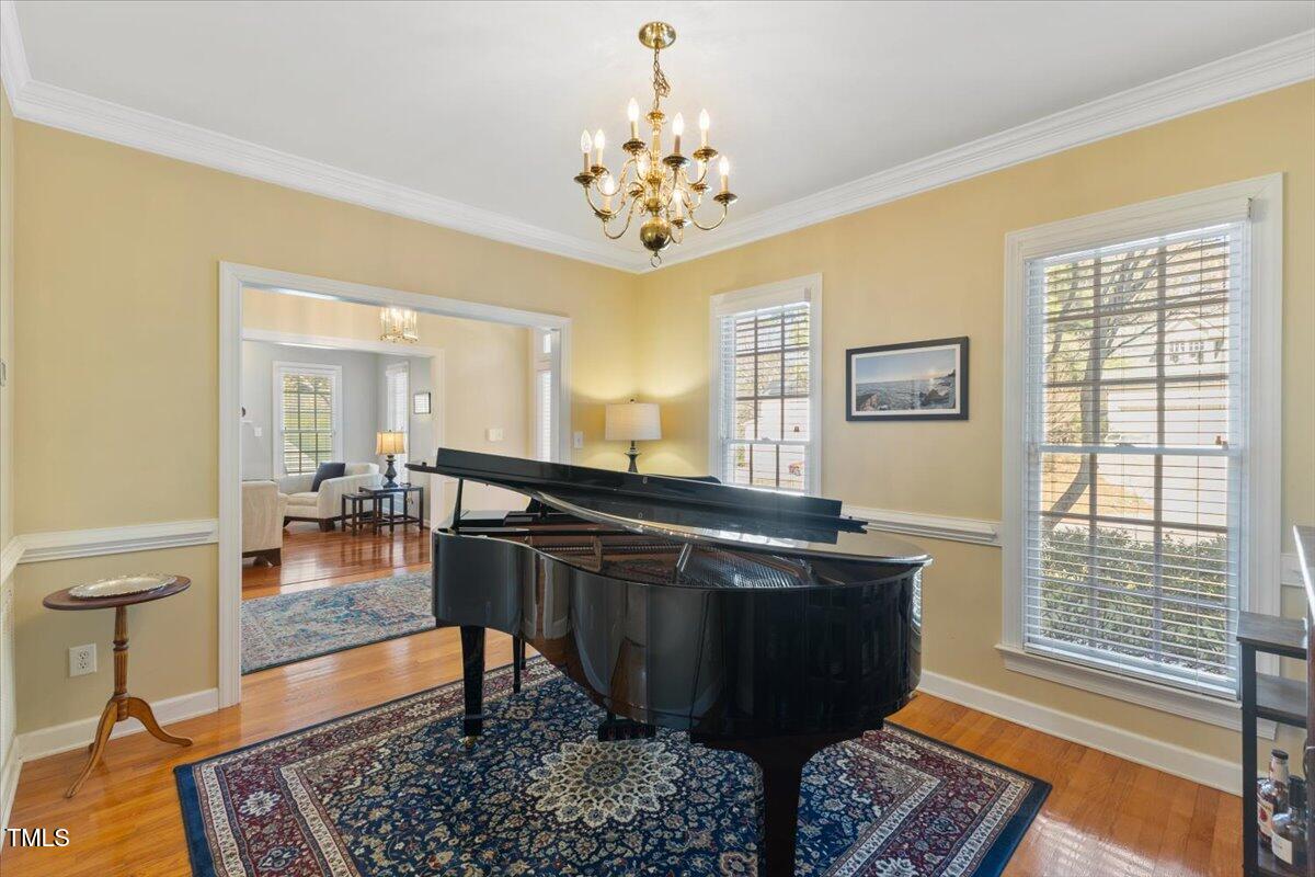 4617 Wee Burn Trail Raleigh, NC 27612 - Photo 6 of 70 a room with table chairs and wooden floor