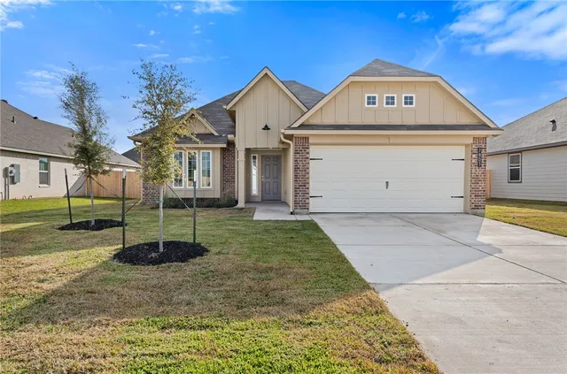 a view of a white house with a yard