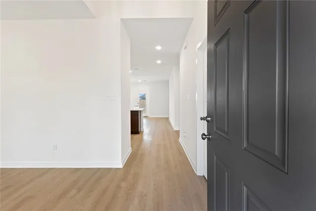 a view of a hallway with wooden floor