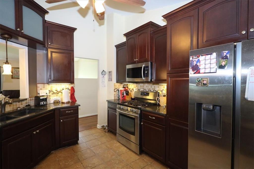 236 Hiram Sudie Road Dallas, GA 30157 - Photo 8 of 26 a kitchen with stainless steel appliances granite countertop a stove a refrigerator and a sink